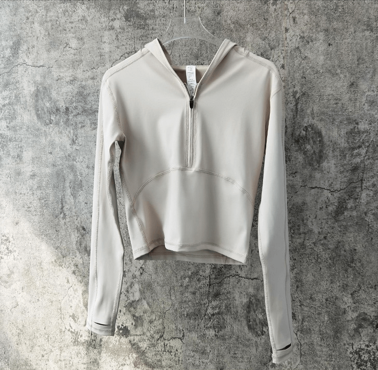 Stylish women's sports top with long sleeves and hood, ideal for yoga. Made of breathable nylon and spandex. Quick-dry fabric.